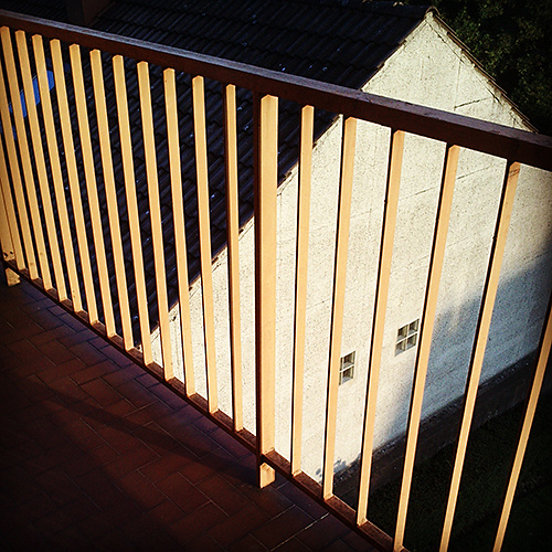Orange railing, white house